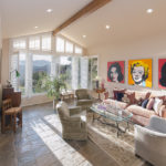 Sunken living room with high ceiling and large windows