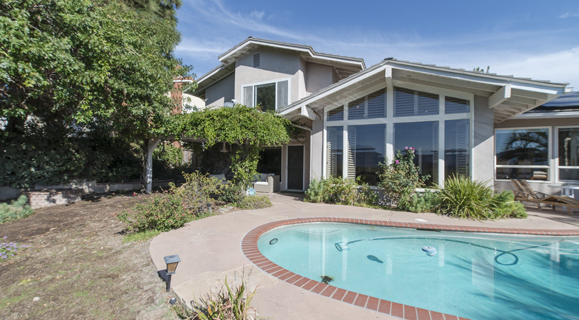 Backyard with pool and covered seating