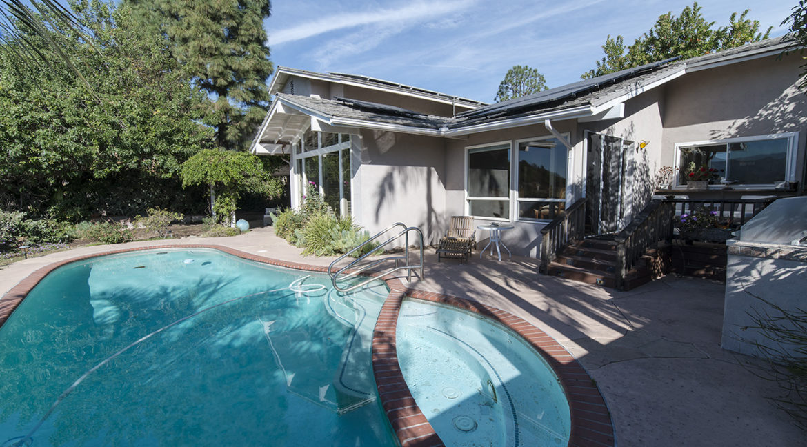 Pool and Spa with view of house