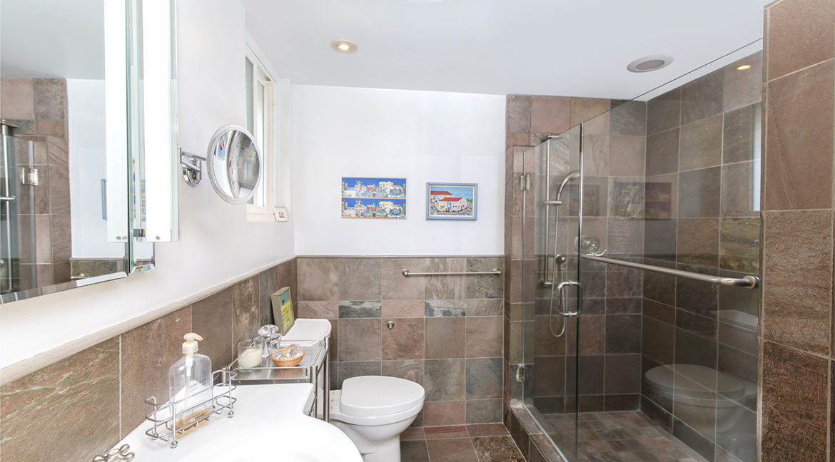Main bedroom with tiled wall shower