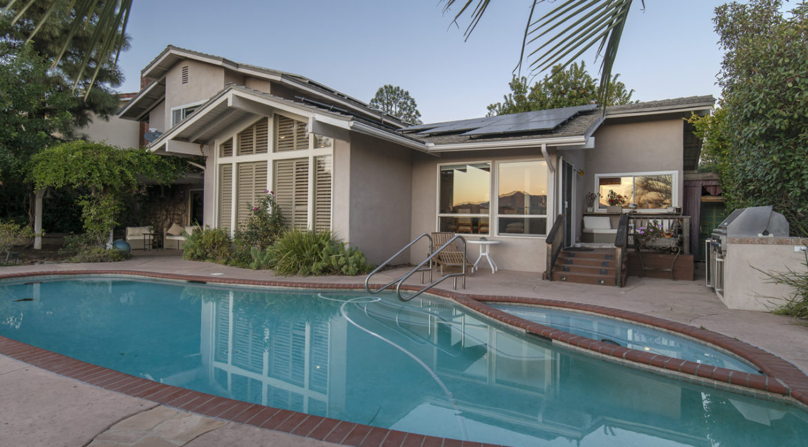 Sunset light on windows, pool and spa