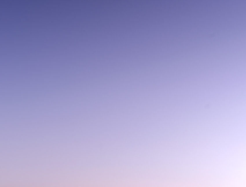 Last light mountain silhouette with crescent moon on the rise