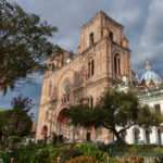 Panoramic view of Cuenca, Ecuador, showcasing historic El Carmen de la Asunción Church with twin towers after downsizing to this secure retirement haven. Shoket Properties.